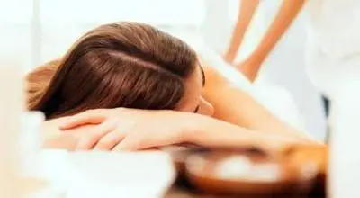 Woman laying on table getting a massage